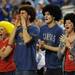 Kansas fans show off their curly hairdos as they cheer from the stands during the second half at Cowboys Stadium in Arlington, Texas on March 29, 2013. Melanie Maxwell I AnnArbor.com
